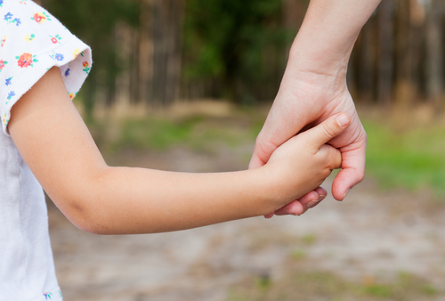 Photo of a mother holding her child's hand