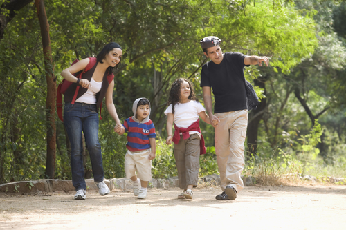 Photo of family walking through a trail together