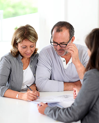 Photo of couple working with a wills and estates lawyer on their estate plan