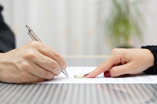 Photo of a couple signing a legal agreement